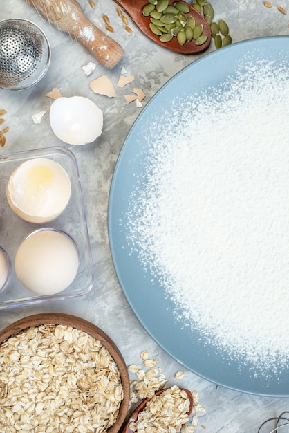 top view white flour with eggs raw cereals and seeds on white background dough pie seed milk cake color corn