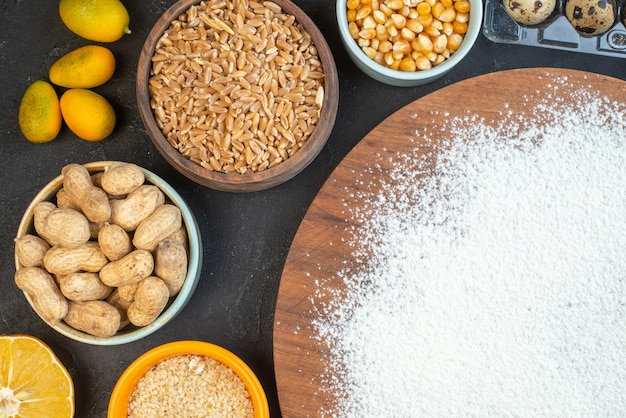 top view white flour with nuts seeds cereals raisins and jelly on dark background food color dough cake pie dust bake