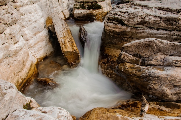 Top view of white mountain river stream flowing among rocks in Martvili canyon