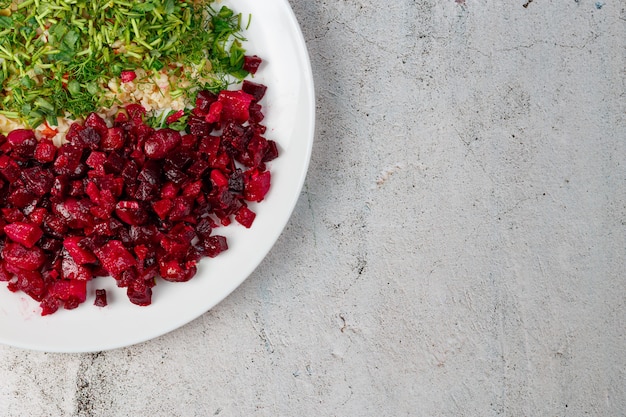 Top view of white plate with fresh salad and rice with micro greens