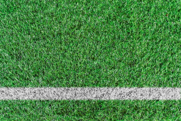 Photo top view of white stripe on green soccer field