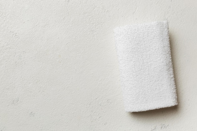 Top view of white towels with copy space on colored background