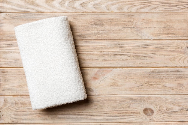 Top view of white towels with copy space on colored background