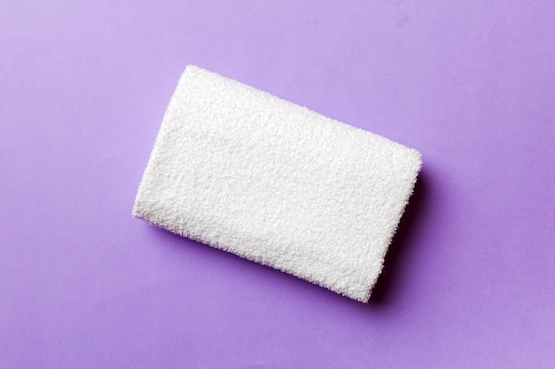 Top view of white towels with copy space on colored background