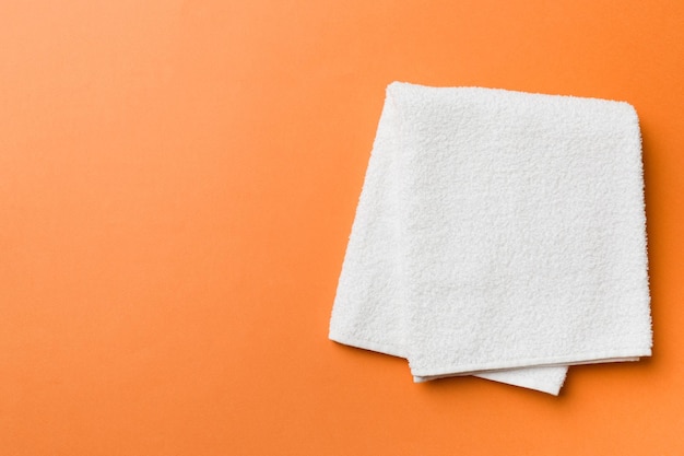 Top view of white towels with copy space on colored background