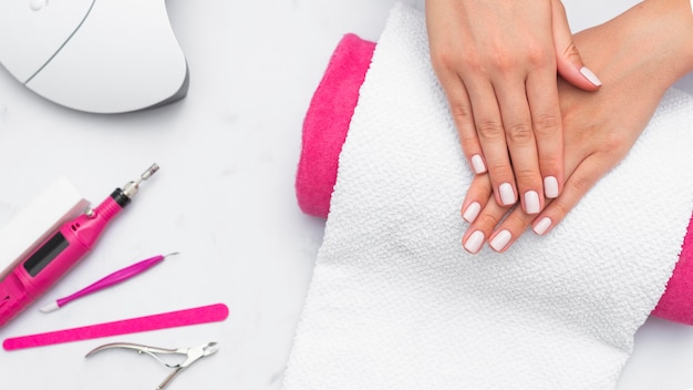 Top view woman getting her manicure done at the salon