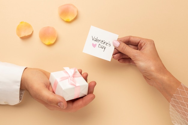 Top view of woman holding gift box in hand for valentines day