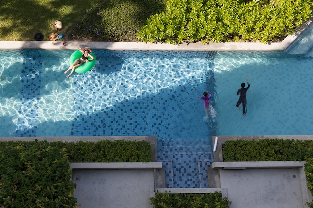 Top view of woman lay on balloon in pool