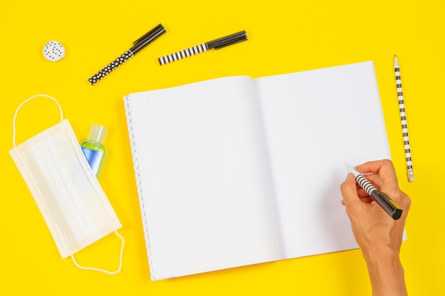 Top view to woman's handwriting on open notebook