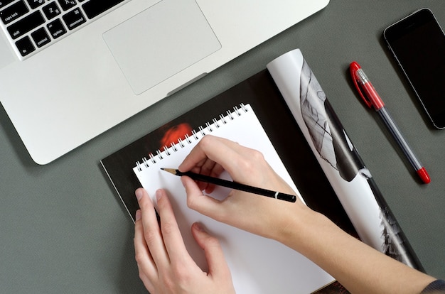 Top view on woman taking notes