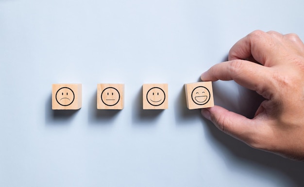 Top view wooden blocks with smiley face graphic Concept for rating and customer satisfaction