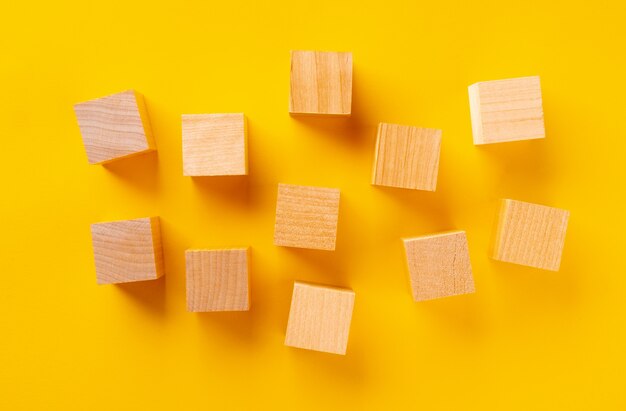 Top view of wooden cubes on yellow