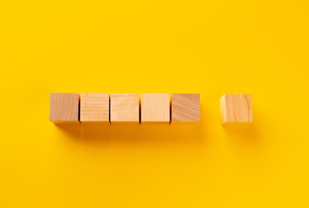 Top view of wooden cubes on yellow