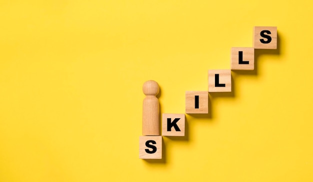 Top view of Wooden figure standing on increasing of wooden step and skill wording for human development concept