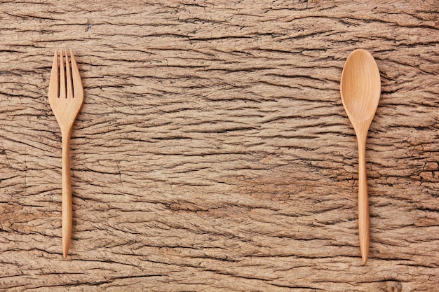 Photo top view wooden spoon fork on wood floor with copy space