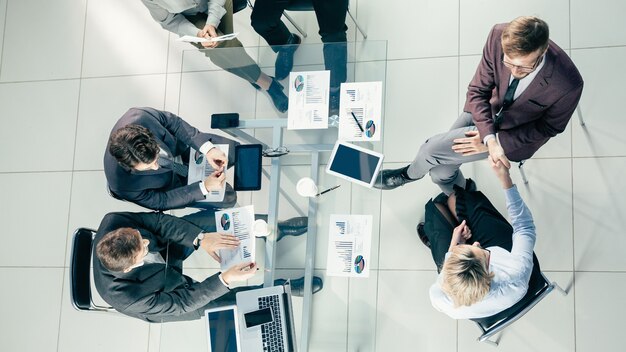 Top view. working group discusses financial indicators at a meeting in the office.