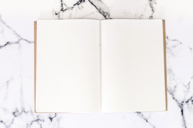 Top view of workspace and opened notebook with mock up blank pages 