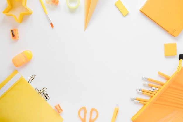 Top view of yellow school supplies