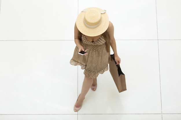 Top view young girl with a straw hat