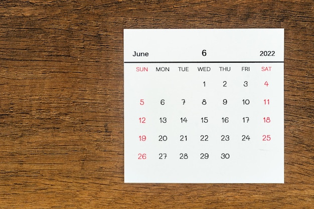 Top views Calendar desk June is the month for organizers to plan and remind on the wooden table background