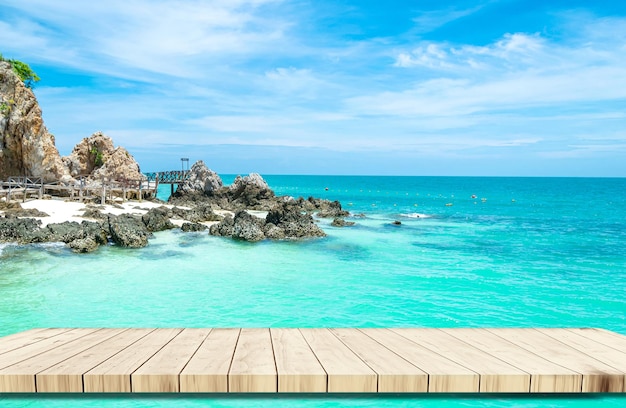 Top of wood balcony table with seascape and palm leaves sea and sky at beach