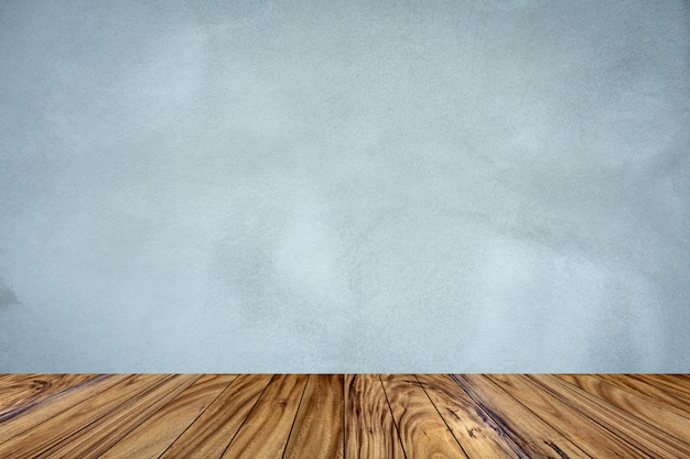 Top wood table perspective on gray cement wall background.