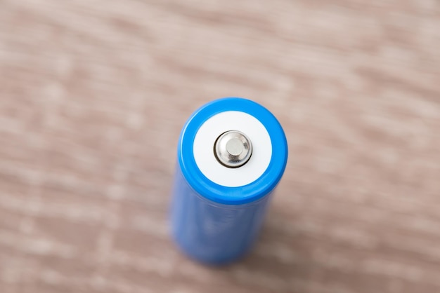 Topdown shot of blue battery showing positive polarity side