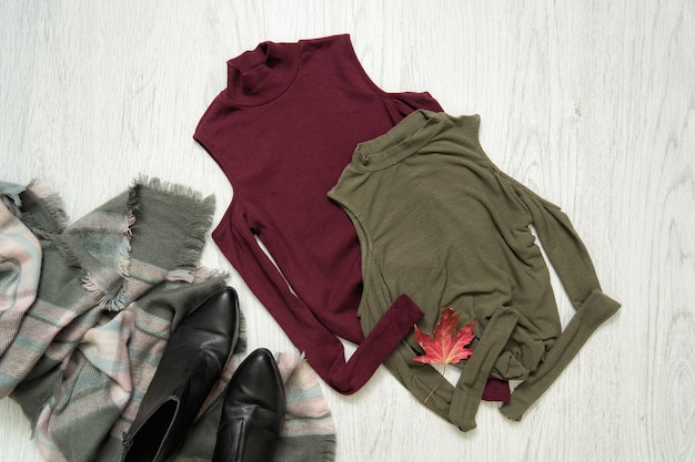 Tops color khaki and burgundy. Scarf and boots. Fashionable concept