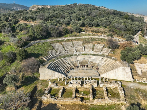 Torbali, Izmir, Turkey: View of the reconstructed theater in the ancient site of Metropolis in Izmir, Turkey, with the village of Yeniköy in the background.