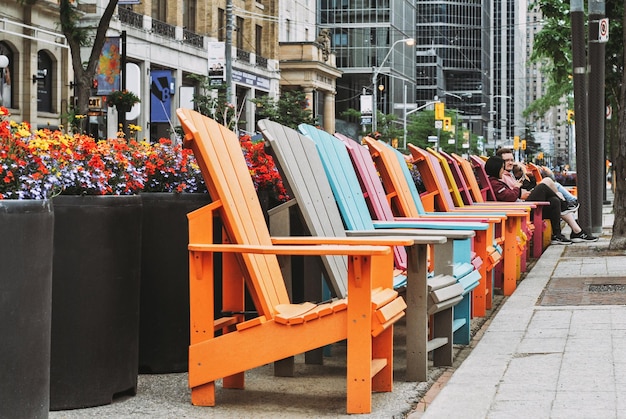 TORONTO, CANADA - 06.11.2022
Multi colored benches on King Street West in Toronto.