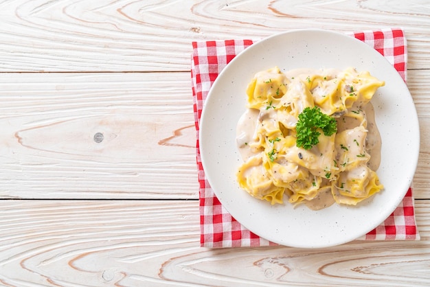 Tortellini pasta with mushroom cream sauce and cheese