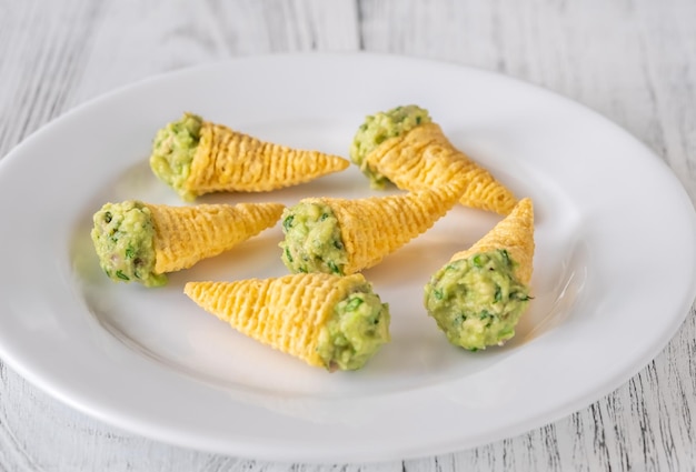 Tortilla chips cones with guacamole