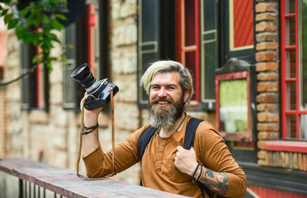 Total relaxation vintage camera capture these memories SLR camera hipster man with beard use professional camera photographer hold retro camera journalist is my career reporter make photo