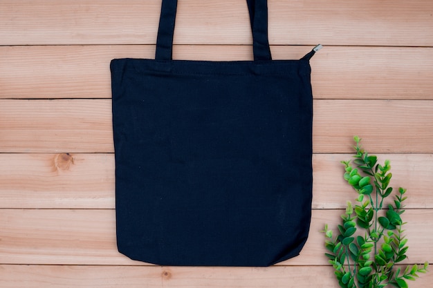 Tote bag canvas fabric cloth shopping sack mockup blank on wood backgroung.