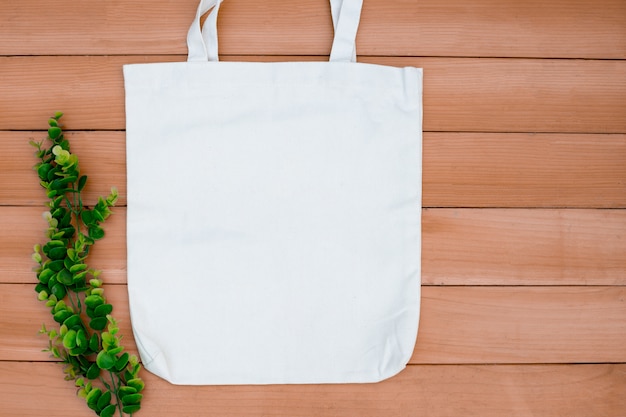 Tote bag canvas fabric cloth shopping sack mockup blank on wood backgroung.