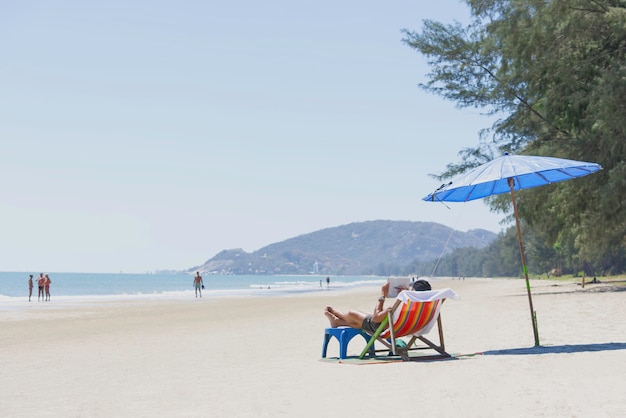 Tourism on canvas bed and umbrellas on the beach Background Blurry Tourism and sea at Suan Son  Pradipat Beach , Prachuap Khiri Khan in Thailand.February 16, 2020