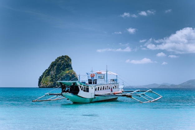 Tourism divers boat in blue cadlao lagoon on island hopping tour El Nido Palawan Philippines