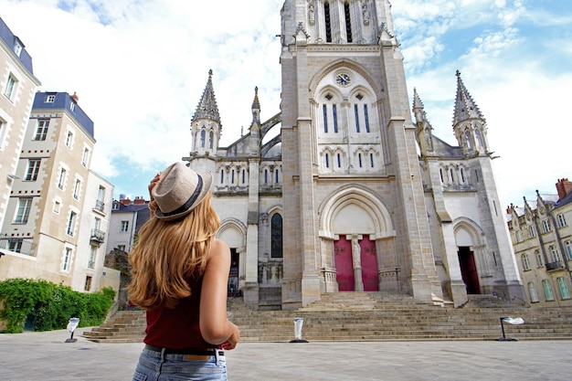 Tourism in France Back view of beautiful tourist girl visiting the city of Nantes France