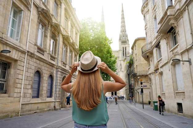 Tourism in France Back view of traveler girl visiting the city of Bordeaux France