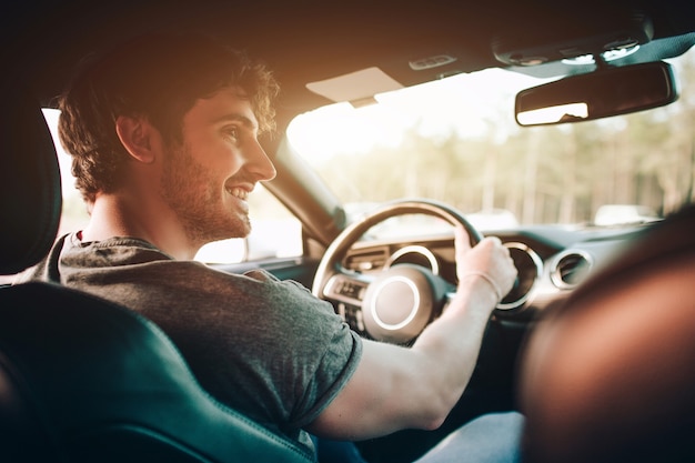 Tourism - Happy young Man and woman Happy sit in a car. Travel and adventure concept.