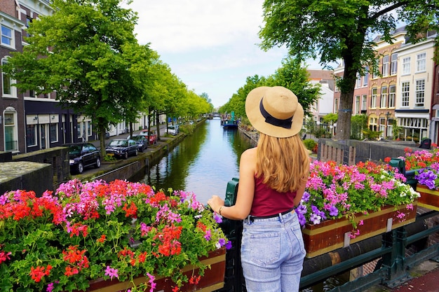 Tourism in Holland Back view of beautiful fashion girl between flower pots in The Hague Netherlands