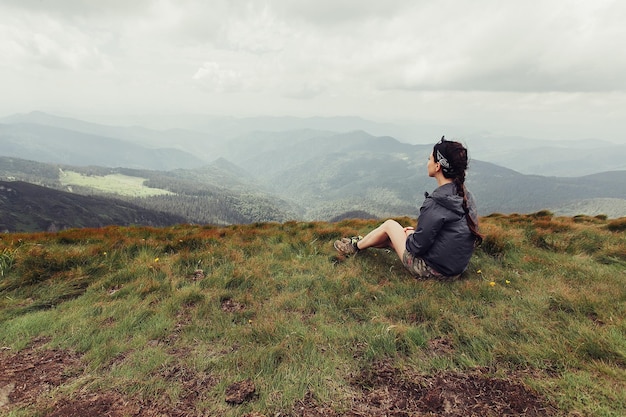 Tourism, mountains, lifestyle, nature, people concept - girl in mountains mountaineering Travel Lifestyle concept landscape on background vacations adventure journey outdoor, human and nature.