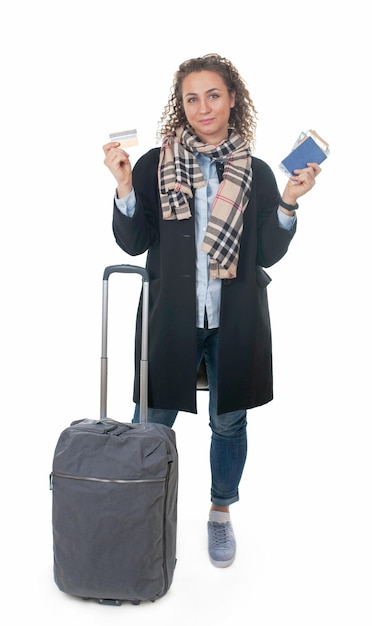 Tourism vacation young girl with travel bag ticket and passport on a white background