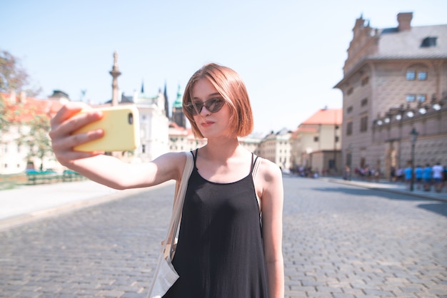 Tourist on background takes selfie streets of the old town