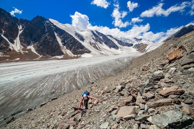 A tourist climbs to the top of the Bolshoy Aktru glacier, Altay, Russia. High quality photo