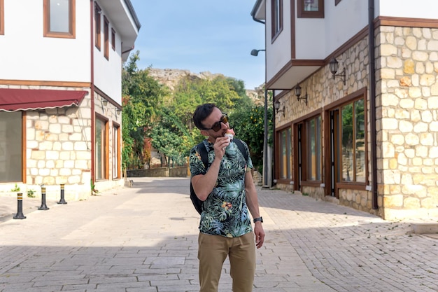 Tourist eat ice cream on the street of an resort mediterranean town