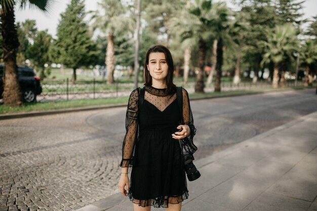 Tourist girl standing with a smartphone