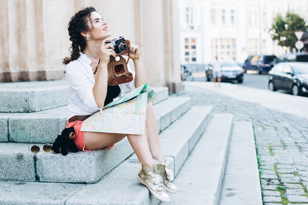 A tourist girl with an old film camera