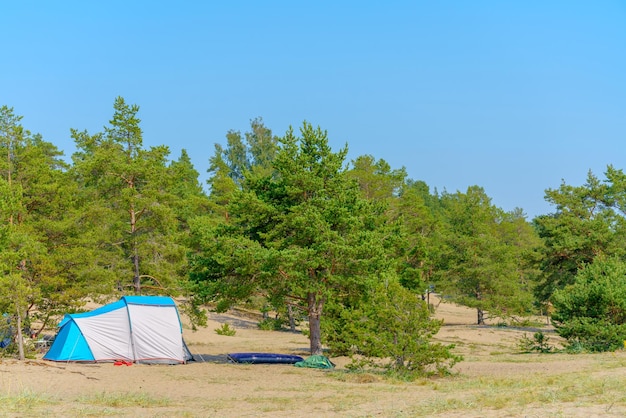 Tourist green tent on the lake Journey to the wild places of nature