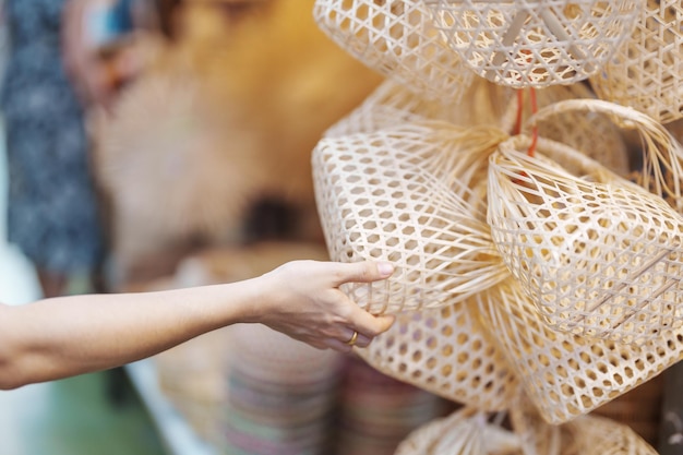 Tourist hand holding Craft bamboo basket in Chatuchak Weekend Market landmark and popular attractions in Bangkok Thailand Travel in Southeast Asia concept